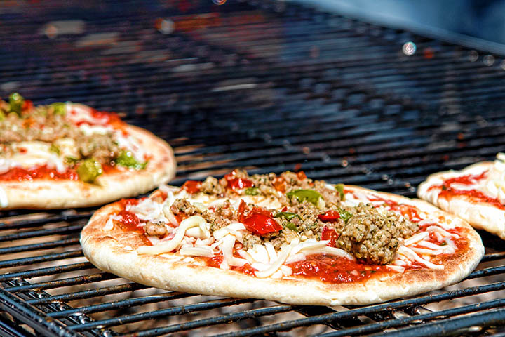grilling pizza on charcoal grill