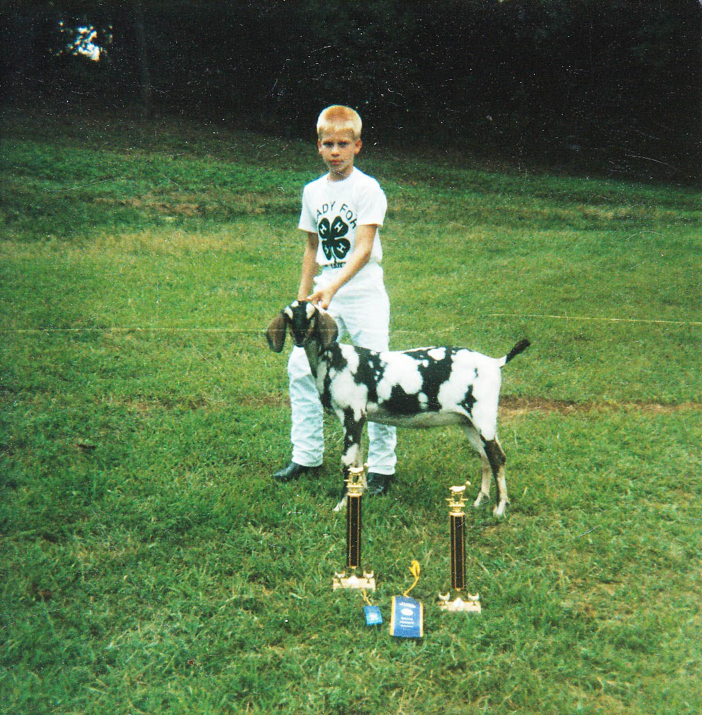 The author's son, Michael with Dinah the goat and their trophies.
