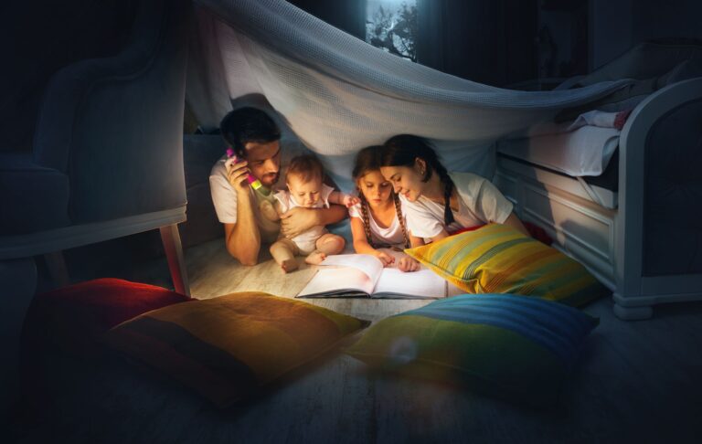 Family with flashlight reading