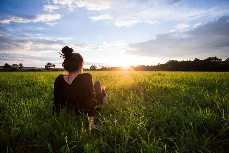 woman sitting in field