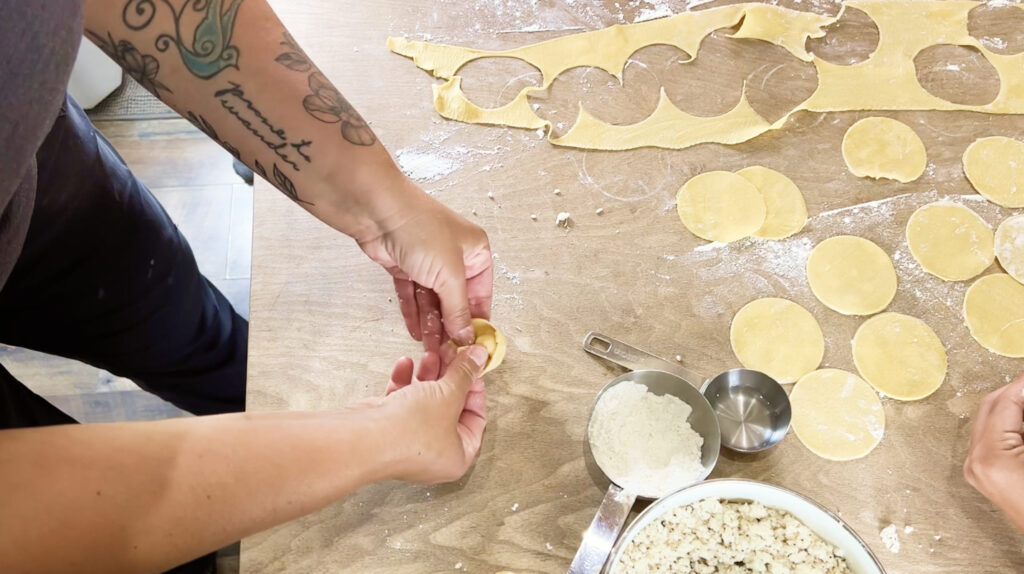 pinching the dough for tortellini
