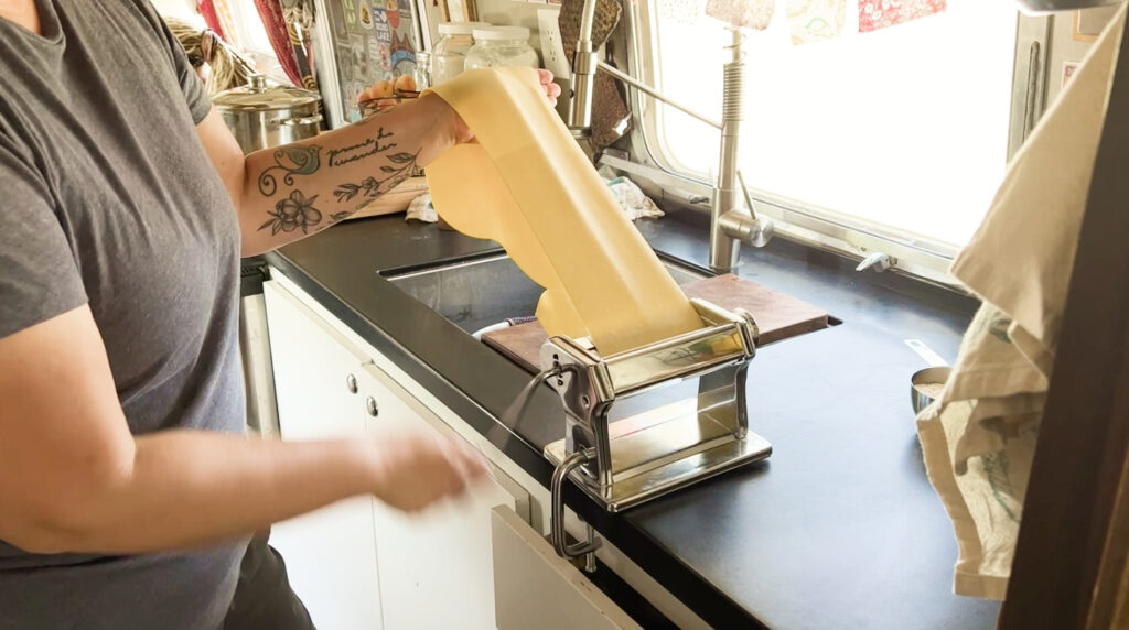 putting dough in pasta machine
