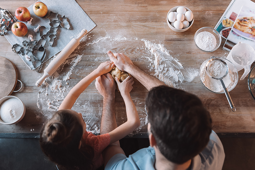 family kneading cookie dough