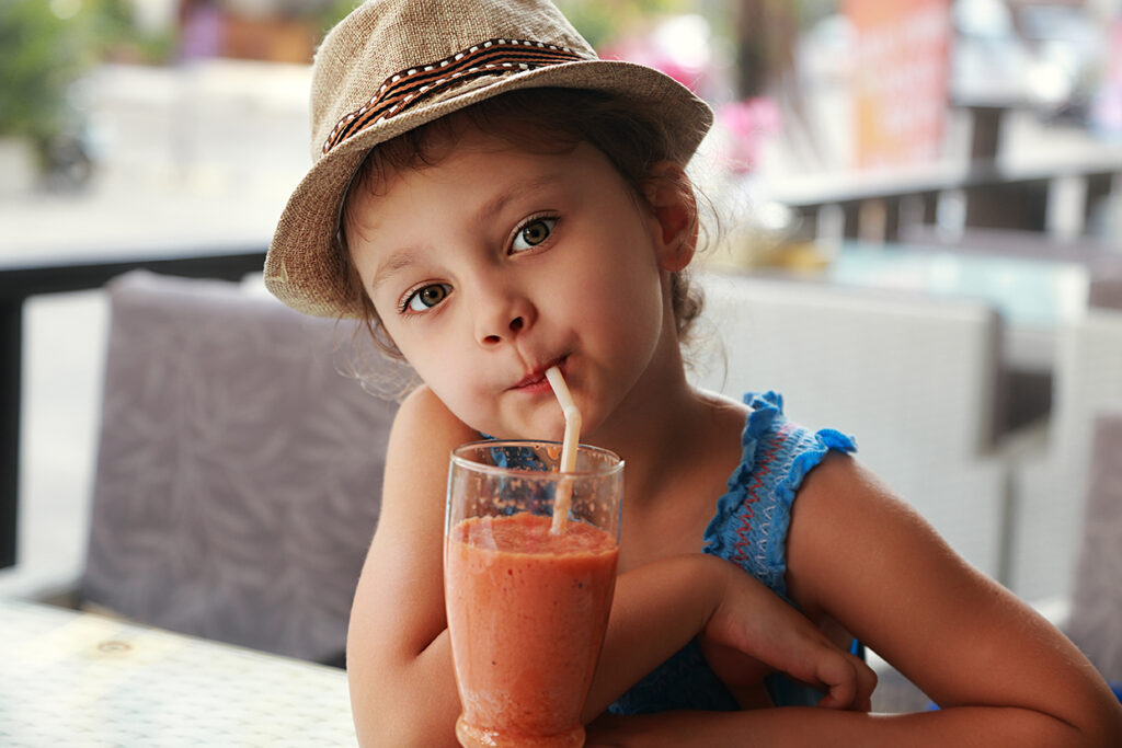 child drinking smoothie juice