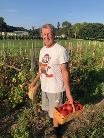 My father-in-law with his heirloom tomatoes in the garden