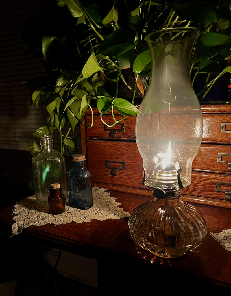 oil lamp lit on table