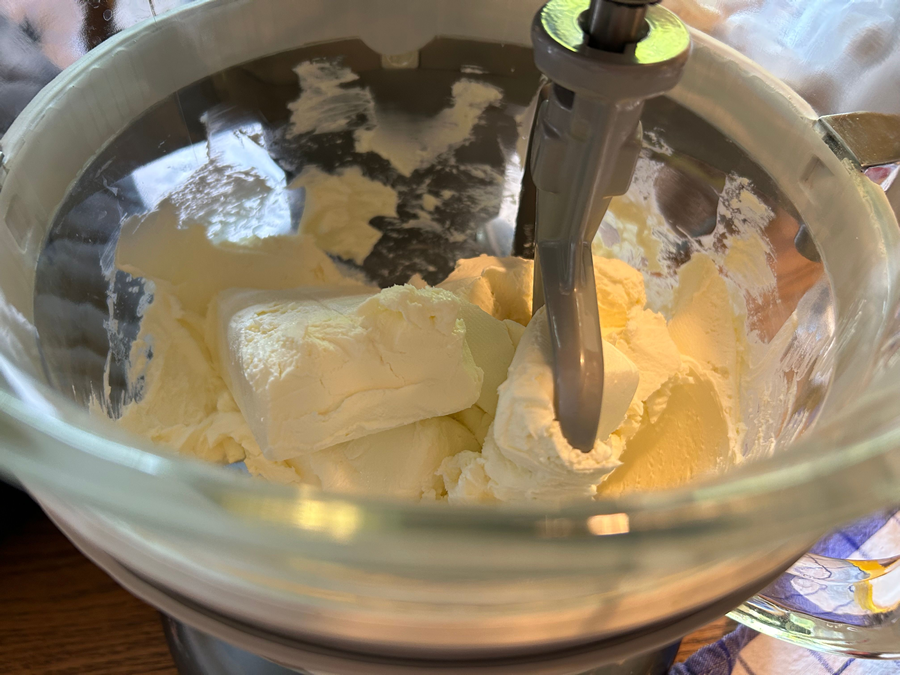 Mix sugar into cream cheese with mixer