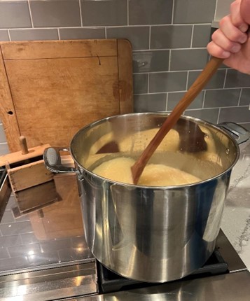 Stirring homemade caramels in a pot