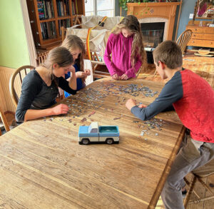 Kids putting truck jigsaw puzzle together