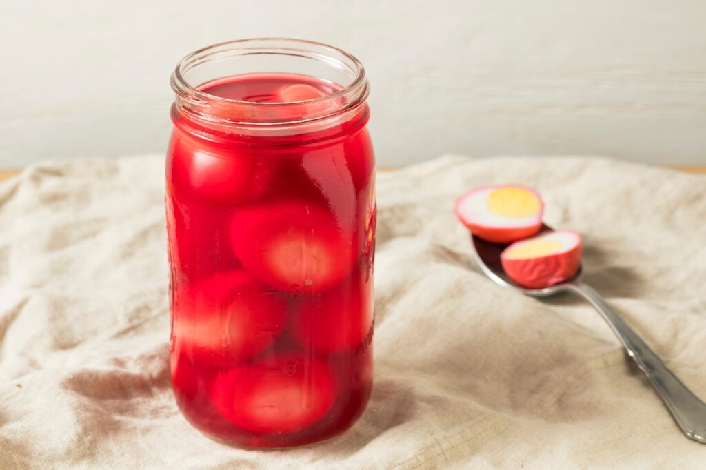 Red pickled eggs in jar