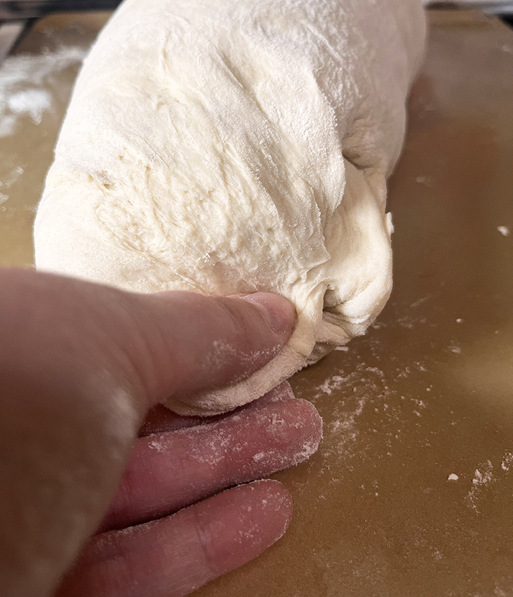 Pinching bread dough into loaf