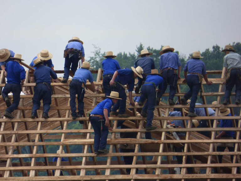 Amish on roof building barn