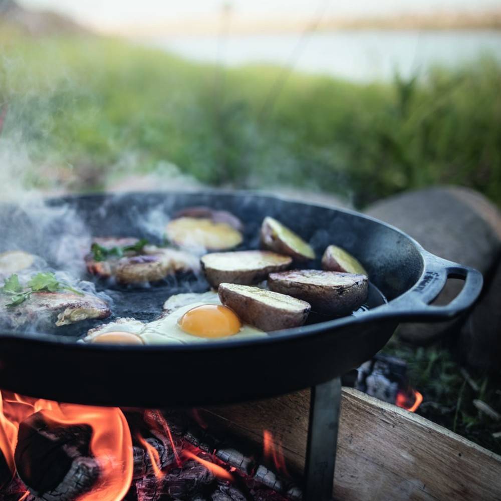 Cooking breakfast over fire in Petromax fire skillet