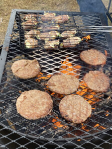 Grilling food over campfire on grate