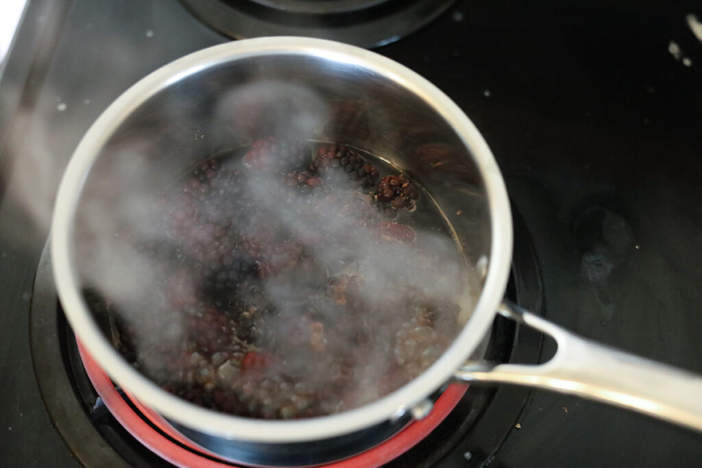 cooking black raspberries in a small pot