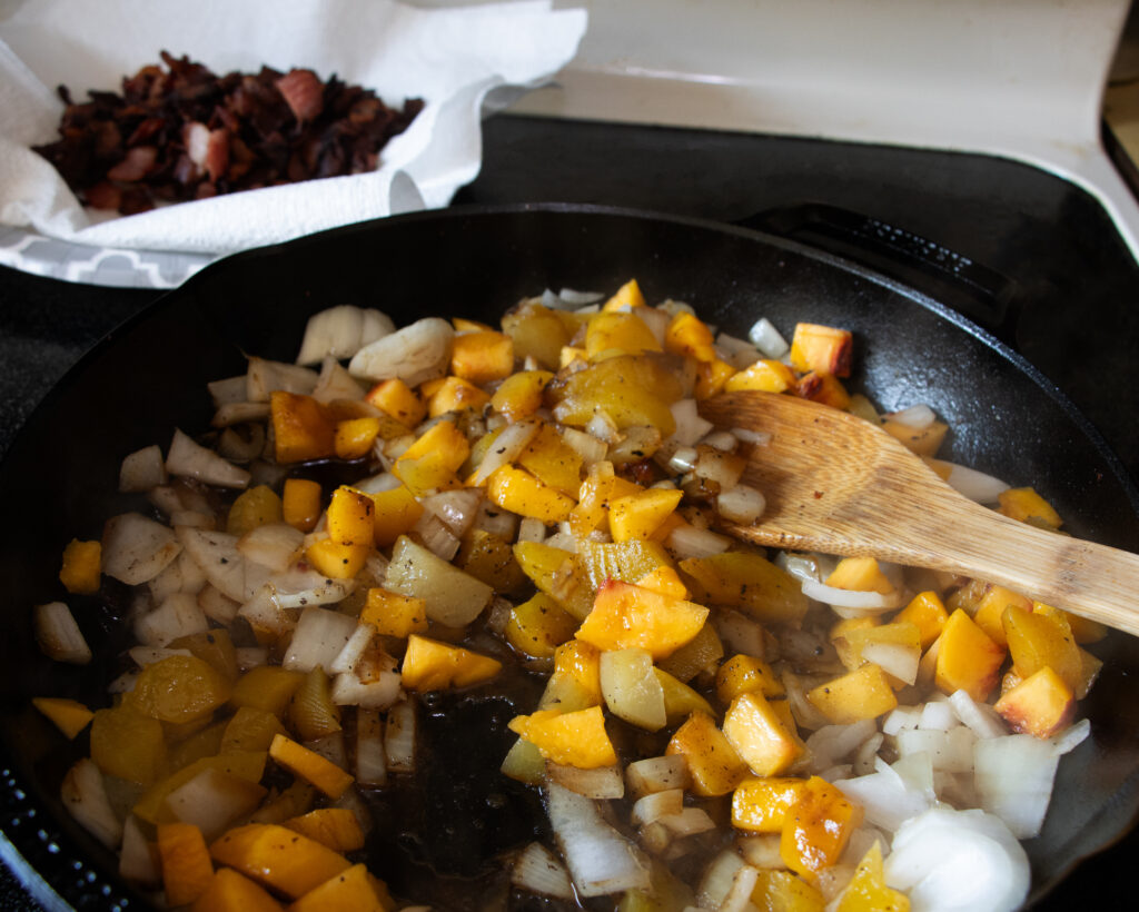 stirring peaches in skillet