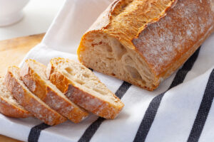 Homemade sourdough bread sliced on kitchen towel